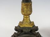 pair of black and gold candlesticks sitting on top of a black base