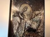a picture of a woman that is hanging on the wall