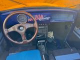 a steering wheel and dashboard of a car with an american flag on it