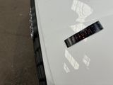 a sticker on the hood of a white car