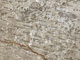 an old map of the world is shown on a table