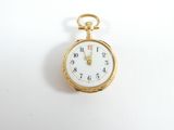 a gold pocket watch with a white face on a white surface