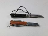 two different types of knives on a white surface