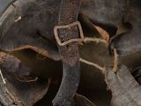a dirty helmet with a metal buckle on it
