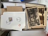 a box full of old postcards and postcards on a table