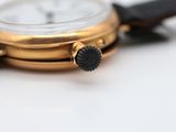 a close up of a watch on a white surface