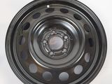 a close up of a steel wheel on a white surface