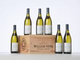 six bottles of white wine in a wooden crate on a table
