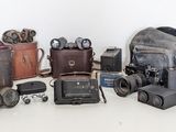 a lot of old cameras and other items on the table