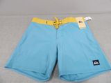 a close up of a pair of blue shorts on a bed