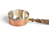a small copper pot with a wooden handle