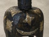 a small wooden horse with a hat on it ' s head