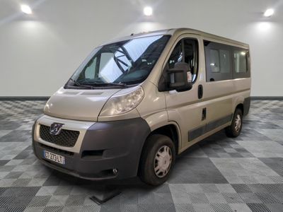 a silver van that is parked on a checkered floor