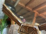 a mirror sitting on top of a wooden table next to a potted plant
