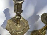 two candles that are sitting on a glass table
