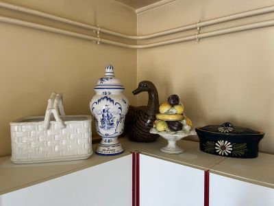 a shelf with a vase, a basket, and other items on it