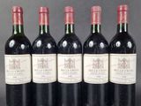 six bottles of wine are lined up in a row