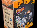 a box of naruto action figures on a black background