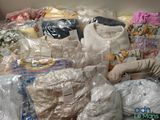 a large pile of clothes that are wrapped in plastic