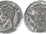 a close up of a coin with a crown on top of it