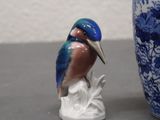 a blue and white vase with a bird on it and a blue and white vase with a bird on it