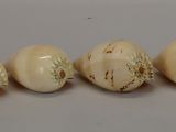 four eggs are lined up in a row on a table