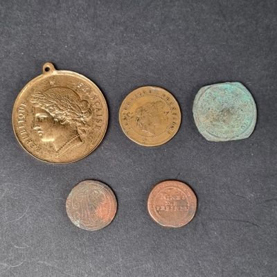 four different coins are shown on a table with a black background