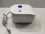 a small white device with a blue button on it