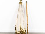 an image of a white and gold towel hanging on a wooden pole