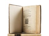 an old book opened to reveal a page of text on a white background