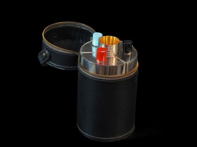 un étui noir contenant une cigarette, sur fond noir