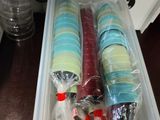 a plastic container filled with assorted items sitting on a counter