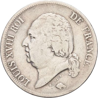 une vieille pièce d'argent sur laquelle figure le portrait d'un homme