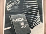 a black and white photo of a book and a stack of books