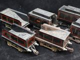 several toy trains are lined up in a row on a black surface