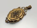 an antique gold locke with a flower design on it