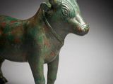 an old bronze figurine of a bull with horns and horns