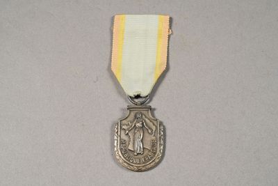 silver medal with a white ribbon around it and a gold ribbon around it