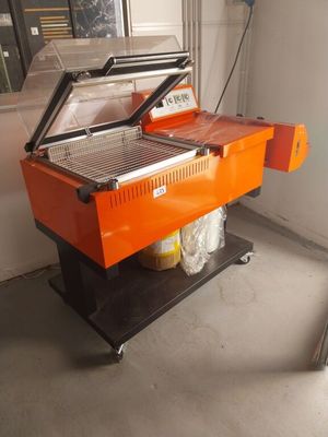 an orange machine is sitting in a room next to a window