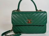 a green chanel bag with a chain strap