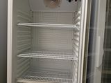 a white refrigerator with a door open in a room