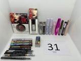 many different makeup products on a white table