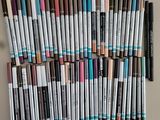 a lot of pens that are lined up on a table