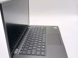 a laptop with a black keyboard on a white surface