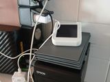 a small printer sitting on top of a table next to a cell phone