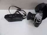 a black camera and a black bag on a white table