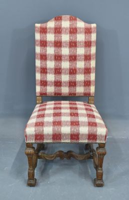 a red and white checkered upholstered chair against a blue wall