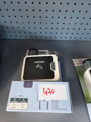 several electronic devices are on display on a shelf in a store