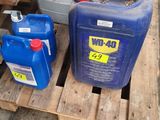 many containers of oil sitting on a pallet in a warehouse