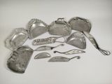 a lot of silverware on a white surface